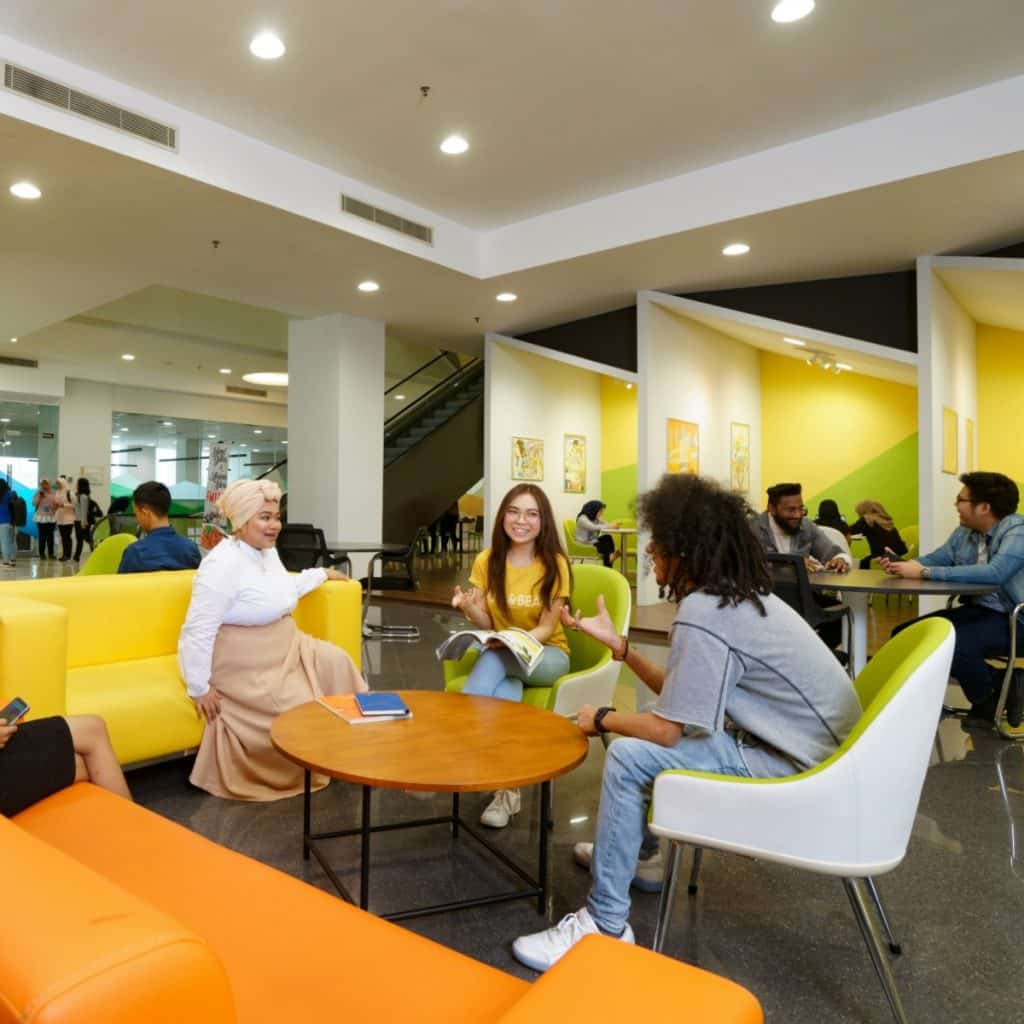 Students Having Discussion in the Library - UNITAR International University