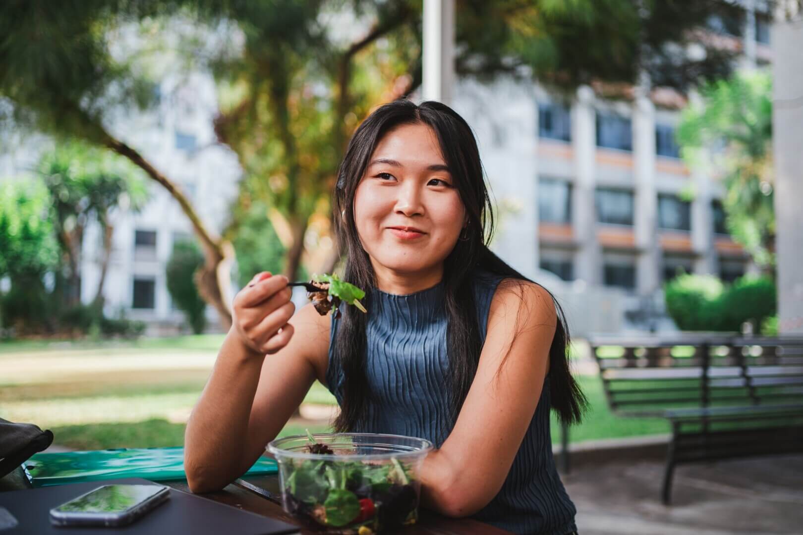 smiling,college,student,girl,eating,a,healthy,salad,while,taking