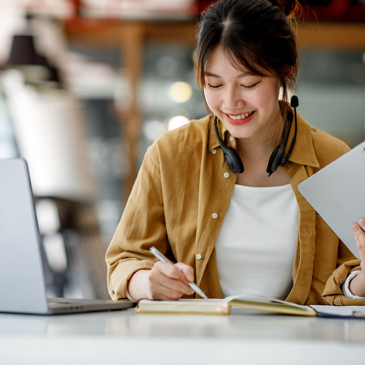 young,adult,happy,smiling,hispanic,asian,student,wearing,headphones,talking