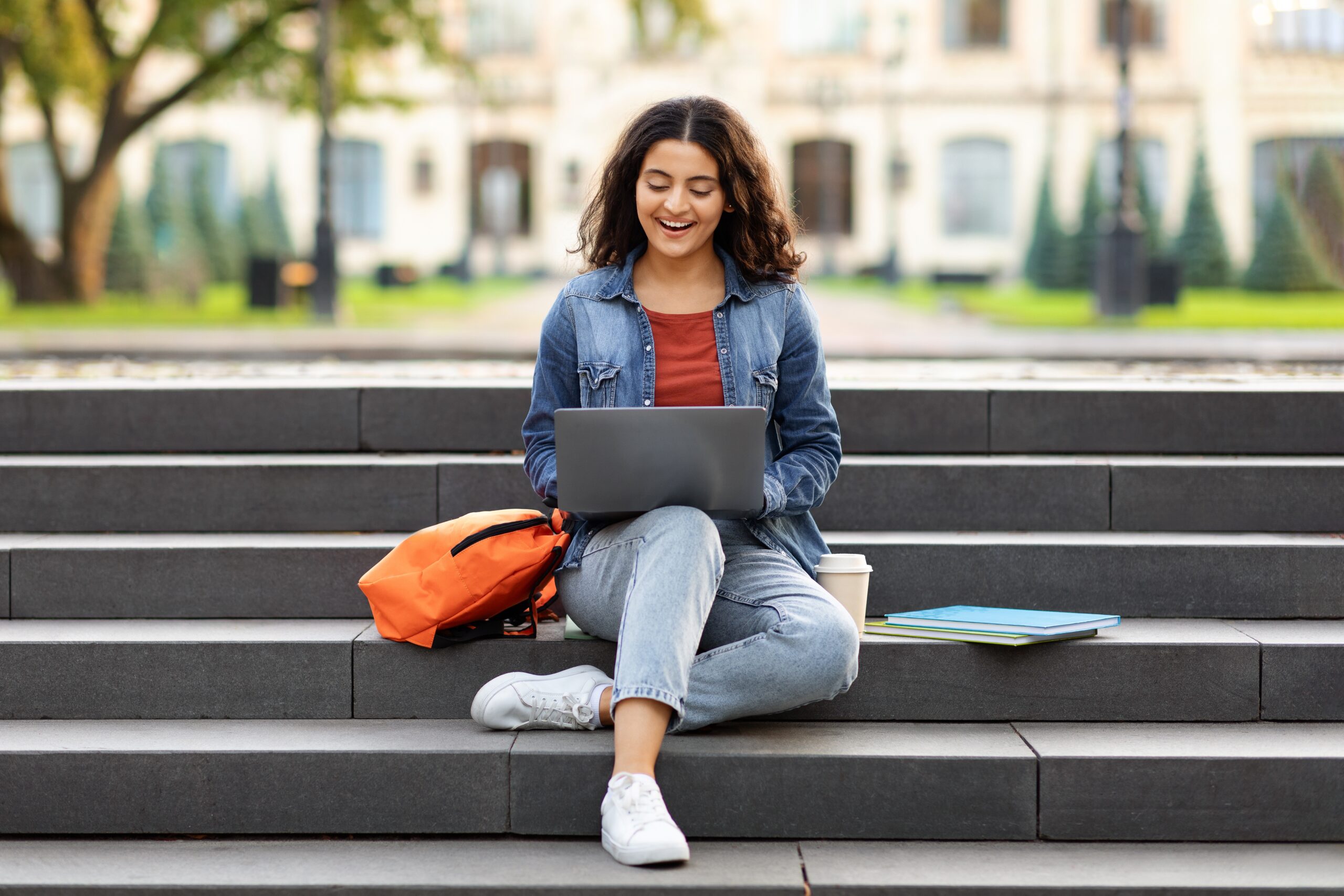 joyful,young,indian,woman,student,studying,online,,using,laptop,computer