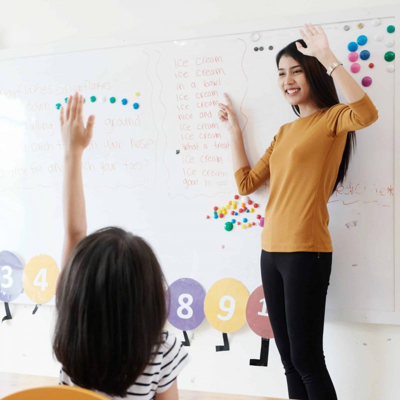 Asian teacher and student at preschool, Young asian woman teacher teaching kids in kindergarten classroom, preschool children education concept